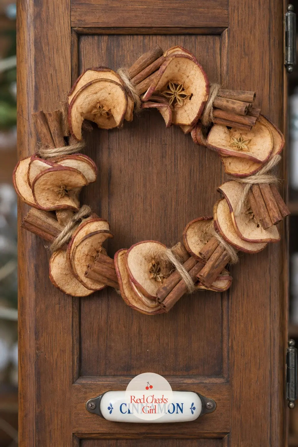 The Cinnamon Stick and Dried Apple Wreath for the Spice Cabinet Door — Bundles of cinnamon sticks tied with plain twine alternate with dried apple slices gone