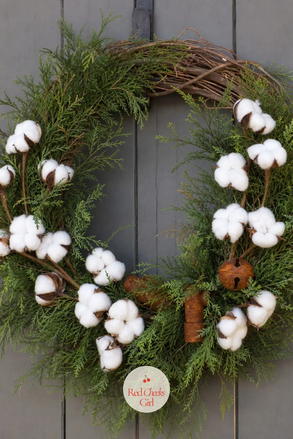 The Cotton Boll and Cedar Wreath for the Workshop Door — Deep cedar green and a few rust-orange accents, pulled from old hardware rather than ribbon, give this