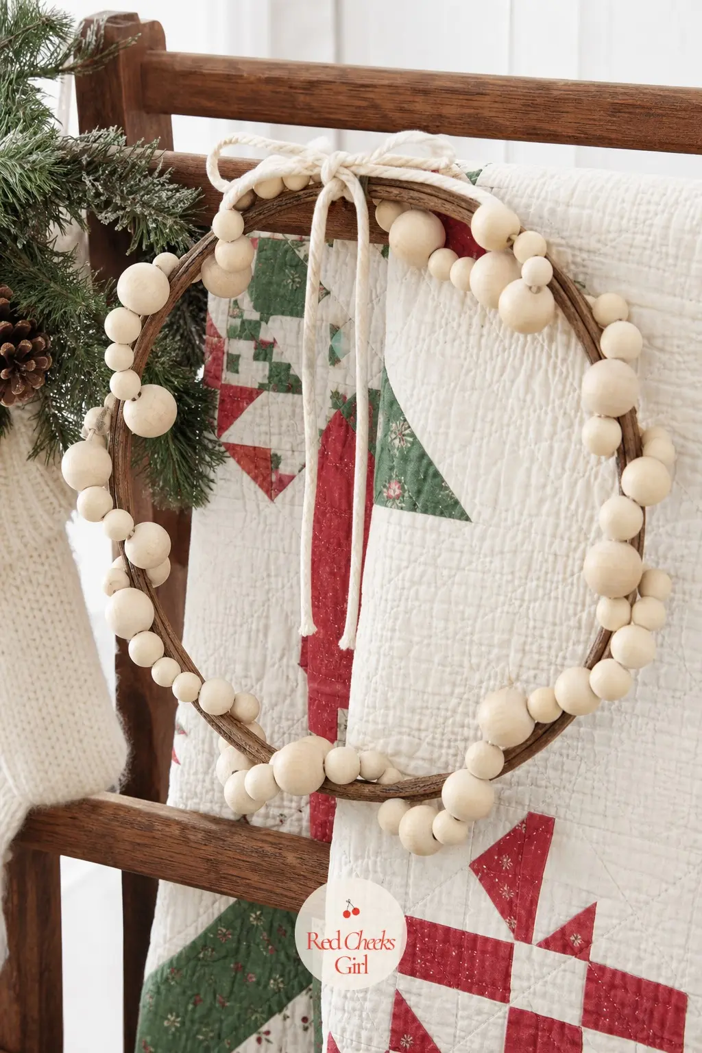 The Wooden Bead Garland Wreath for the Quilt Rack — Strands of natural wood beads wind around a bare wreath form here, with no greenery at all, just wood