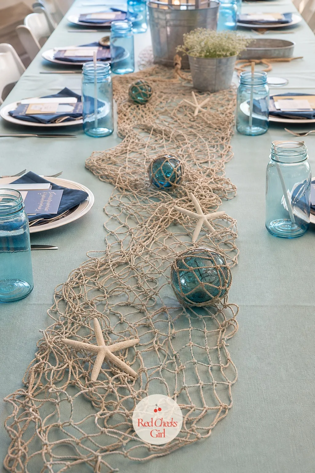 A Fishing Net Across the Table — A bare tablecloth, however good the color, looks unfinished the second the plates come off it. Fishing baby shower theme