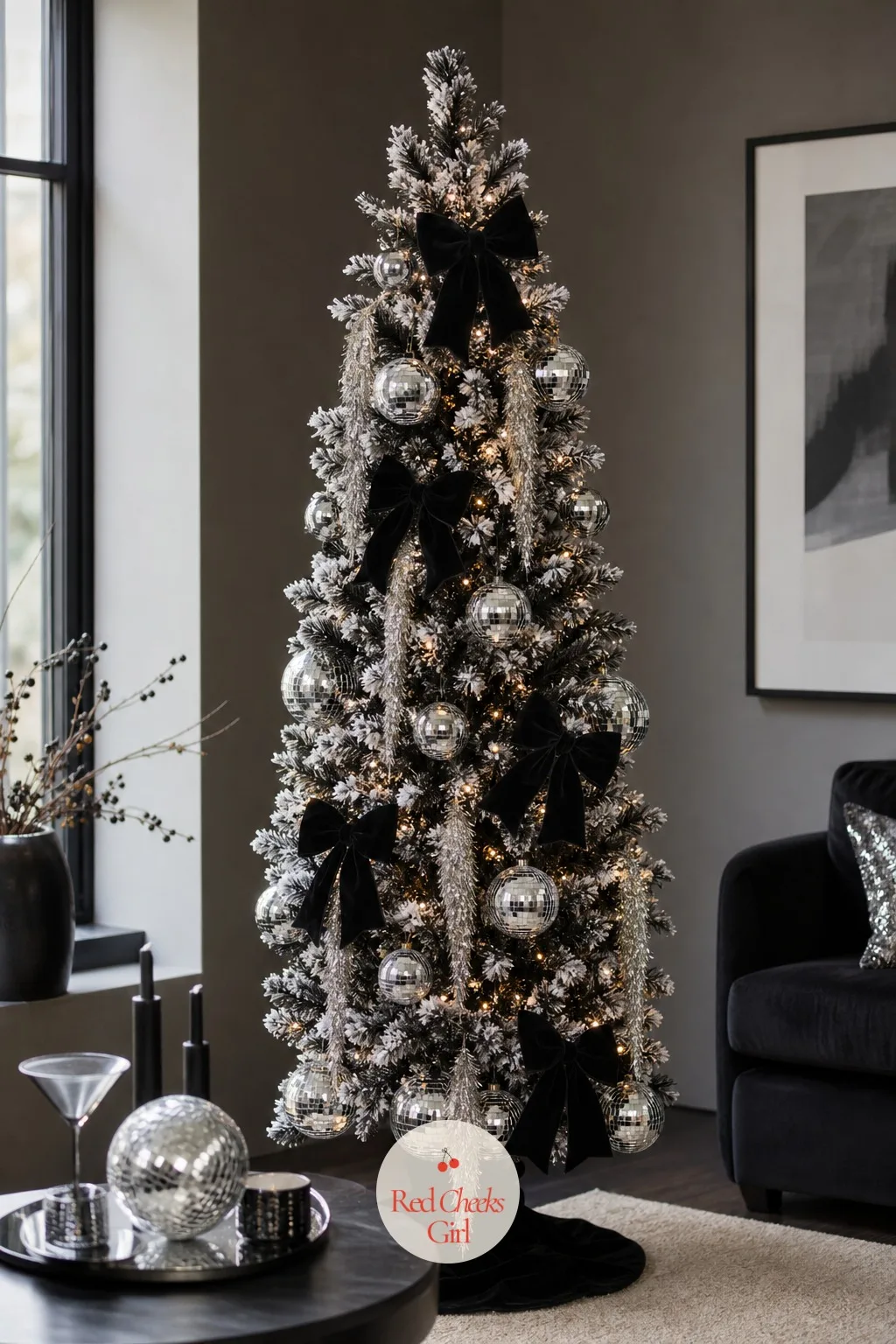 The Flocked Noir Tree — She would never ask for a black tree outright, but flocked black is a different proposition, white snow over a near-black branch