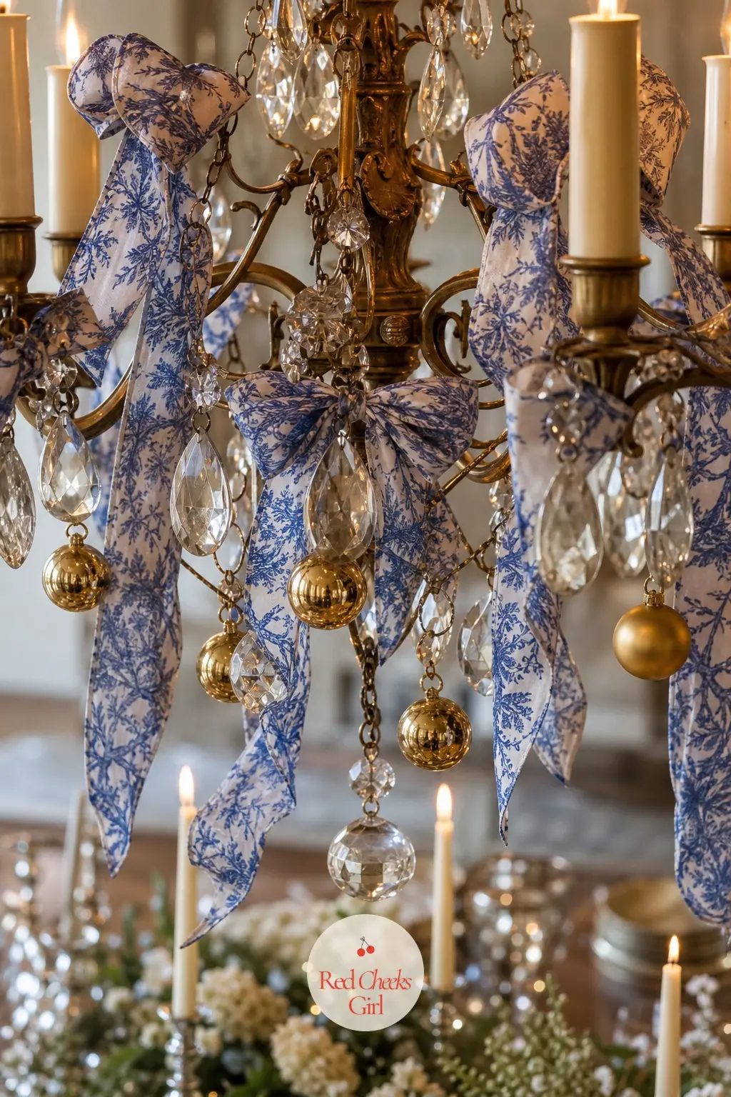 The Chandelier, Dressed Above the Table — The light fixture over the dining table gets its own small treatment: a few lengths of toile ribbon tied along the