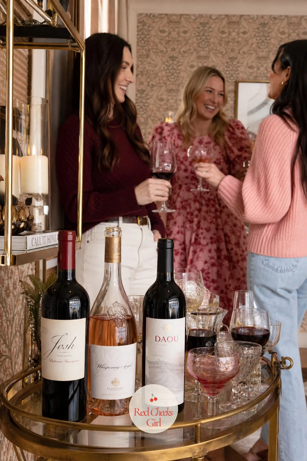 The Wine Station — Off to one side, a small station does the pouring so the host never leaves her seat: a few bottles of red and rosé standing on a tray with a