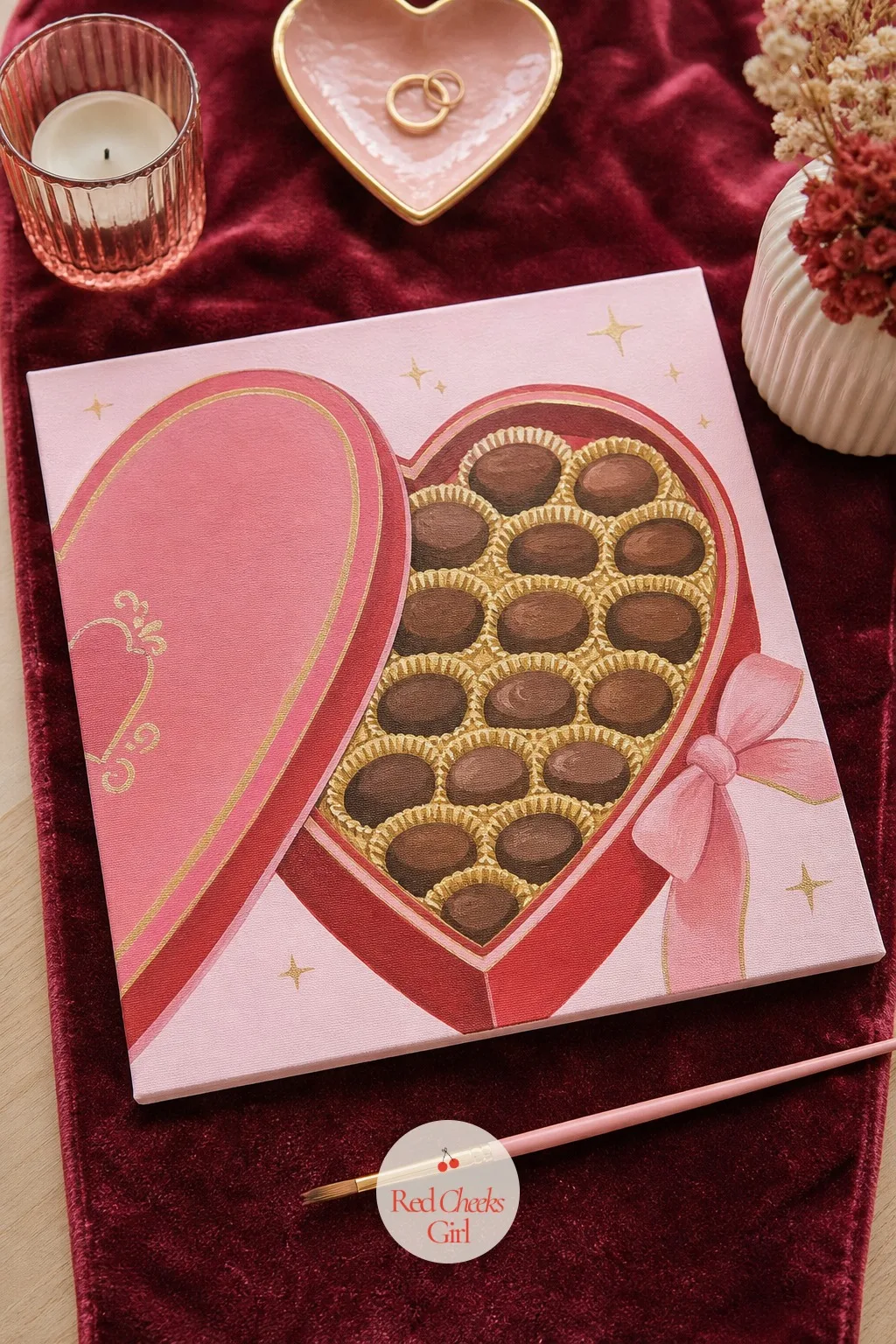 Open Heart-Shaped Box of Chocolates — An open heart-shaped box, a few chocolates nestled in gold pleated paper, with one ribbon trailing off the side, carries
