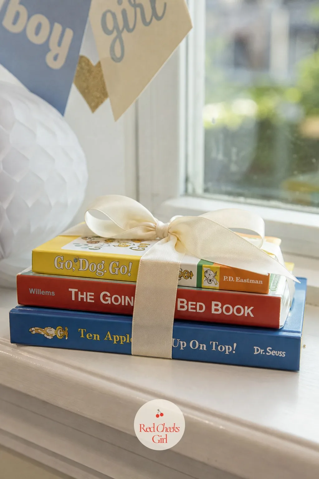 Stack of Board Books Tied With Ribbon — A single book gets read twice and forgotten. Gender reveal gift ideas