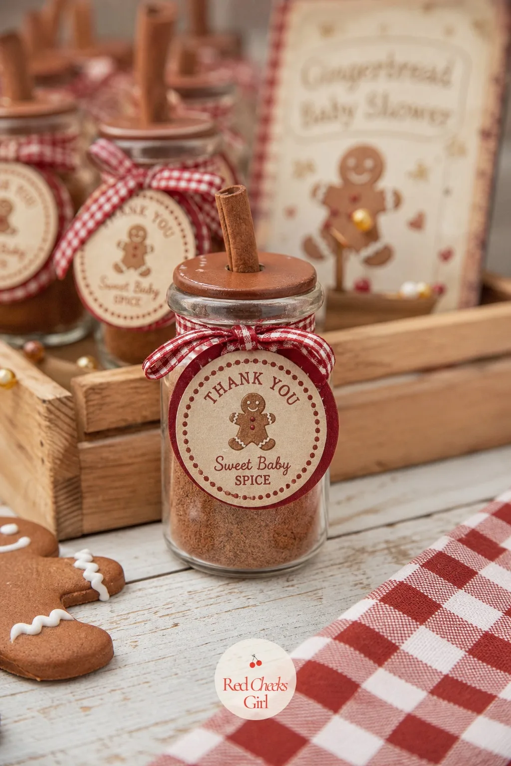 Spice Jar Favor — A small glass jar filled with a mixed baking spice blend, a cinnamon stick poking out the top, ties with a round recipe card tag printed with