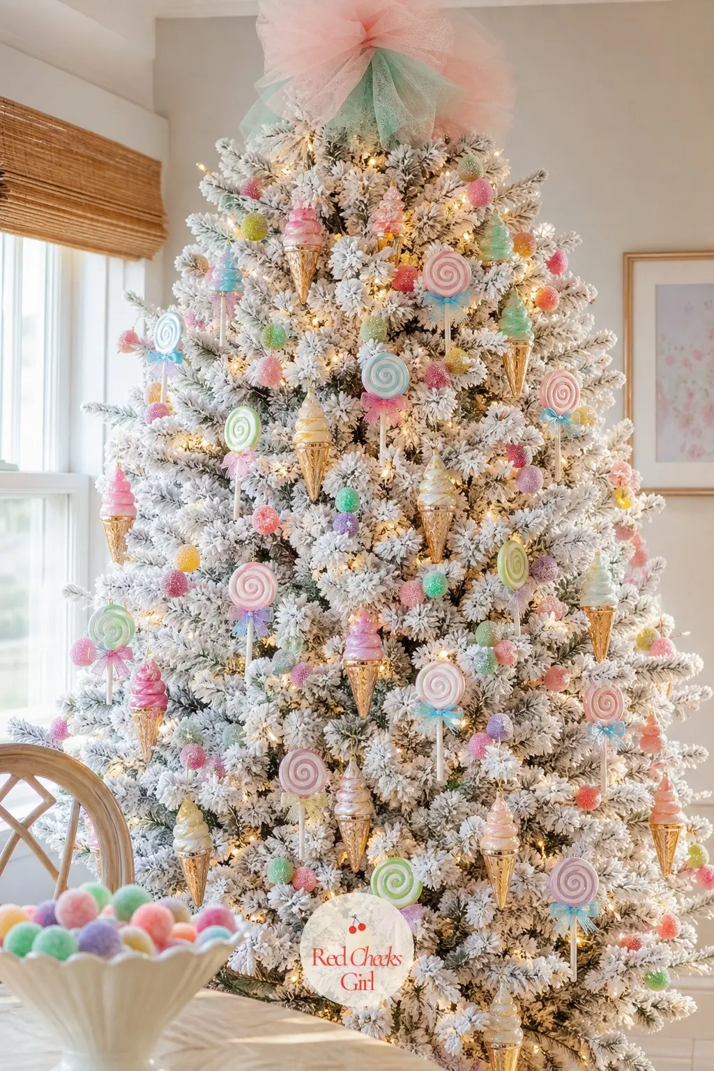 The Flocked Candyland Dream — A flocked white artificial tree, full and wide, carrying mini glass ice cream cones and lollipop discs instead of anything brown
