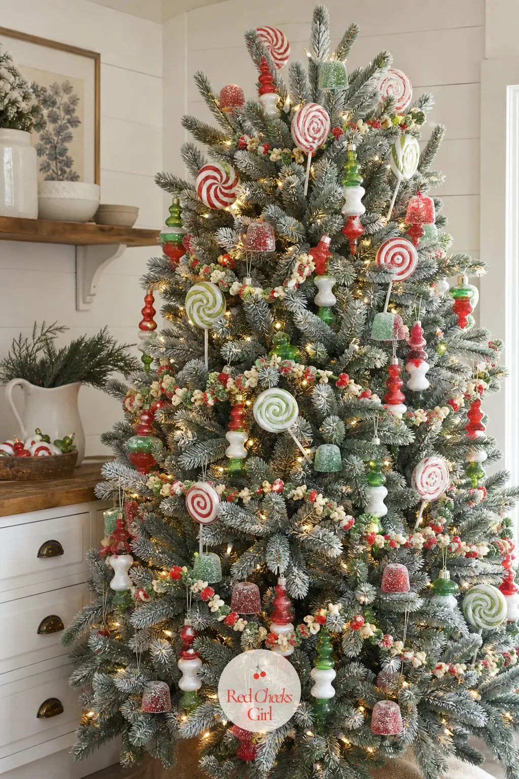 The Real Spruce in Peppermint Stripes — A real blue spruce, full and dense, carrying oversized faux lollipop swirl picks instead of the usual candy cane.