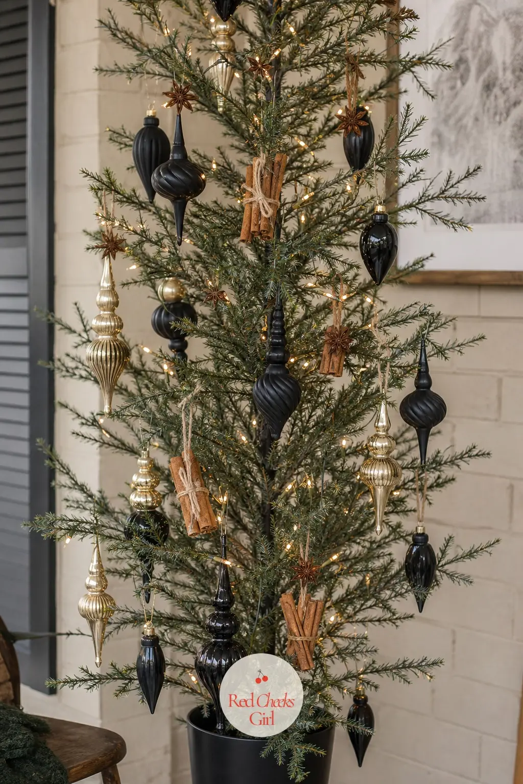 The Sparse Spice Branch in Black and Gold — An artificial tree with thinned, twig-style branches, carrying black and gold glass finials alongside star anise