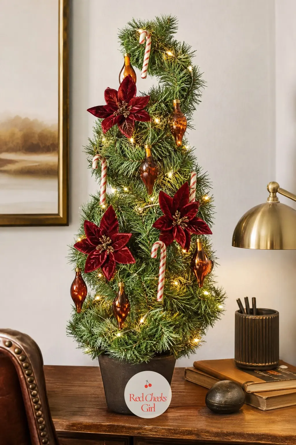 The Toffee and Peppermint Topiary — A small spiral-cut artificial topiary tree rather than a traditional cone shape, dressed in amber toffee glass drops and