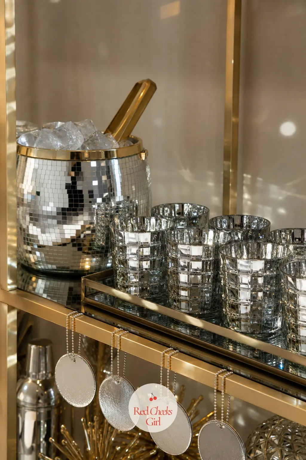 The Ice Bucket and Glassware Shelf, Catching the Light — A disco ball ice bucket sits on an open shelf near the drinks station, its mirrored facets doing