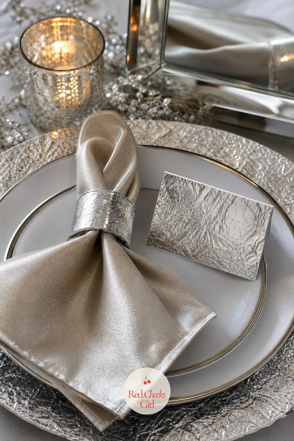 The Place Setting, Finished in Silver Foil — Each setting closes with a silver napkin ring and a place card cut from foil card stock, the guest's name catching