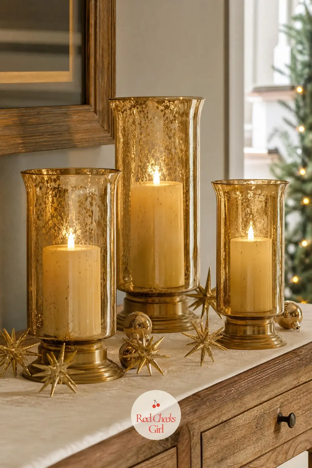 The Entry Table, Lit with a Row of Gold Hurricane Candles — An entry table only needs one job at Christmas: glow. Gold christmas decorations