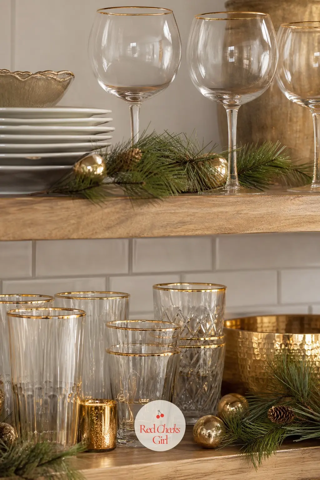 The Open Shelves, Styled with Gold-Rimmed Glassware and Pine — Open kitchen shelves already do half the styling work by being visible all year, so Christmas