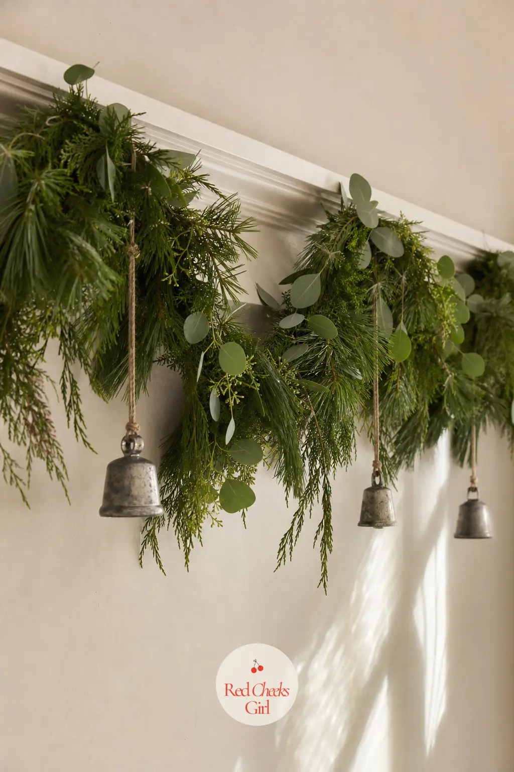 The Garland Swag, Looped Along the Picture Rail — A swag of faux pine looped loosely along the picture rail brings the greenery up and around the walls without