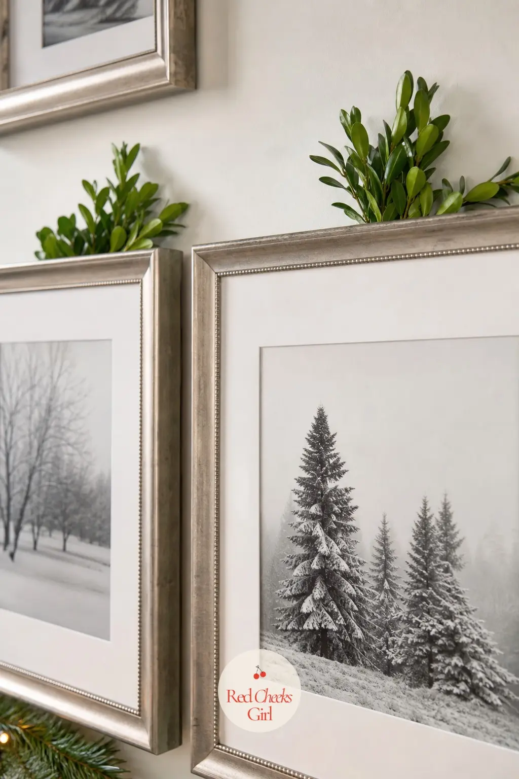 The Picture Frames, Edged With Boxwood Clippings — A single sprig of boxwood tucked behind the top corner of each hallway frame repeats the same green as the