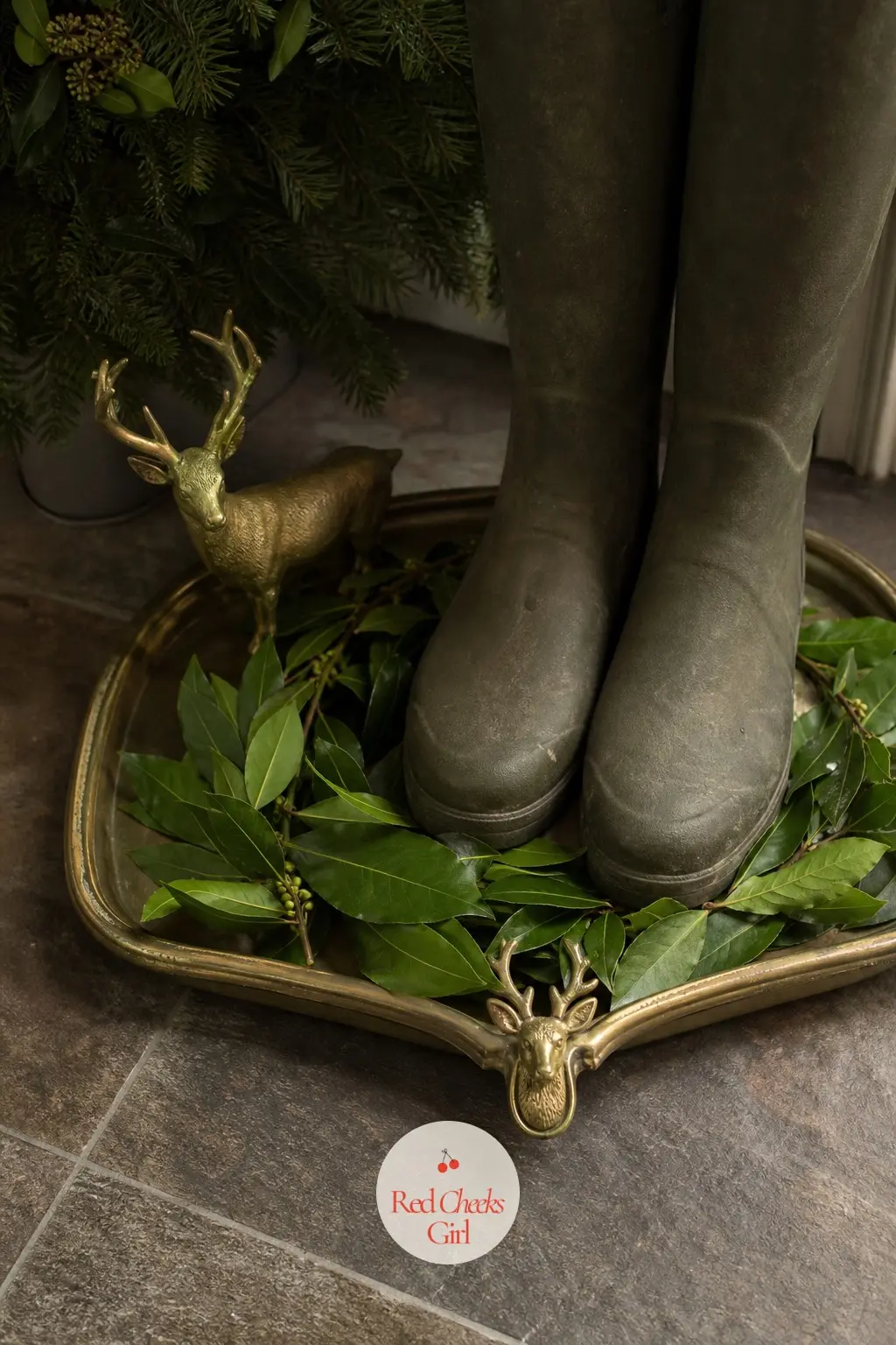 The Boot Tray, Lined with Fresh Bay and a Brass Stag Buckle — Wet boots need somewhere to live, and a plain brass tray lined with a ring of fresh bay leaves