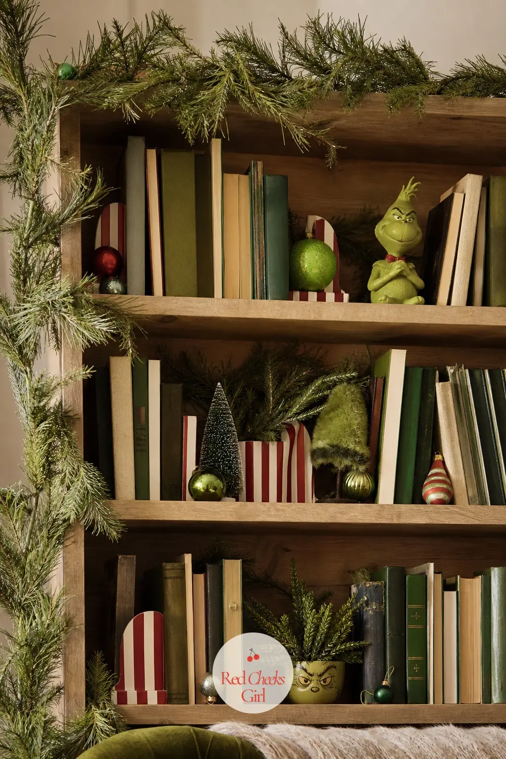 The Bookshelves Gone Slightly Feral — Faux pine tucked along the shelf edges, a pair of striped bookends holding up the usual titles, and a few ornaments