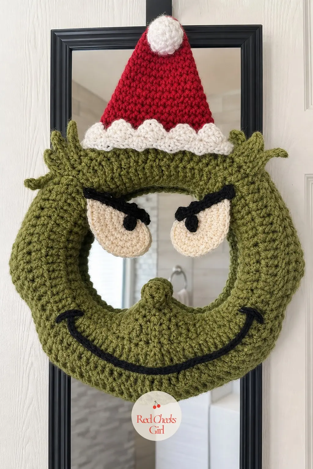 A Crochet Grinch Face Wreath for the Guest Bathroom Door — For anyone who already has a yarn stash, a crocheted face wreath is slower to make than any other