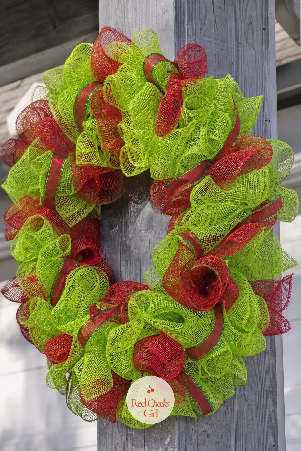 A Lime and Scarlet Deco Mesh Grinch Wreath for the Porch Column — Deco mesh gathers into full, ruffled puffs far faster than fur, which makes it the right
