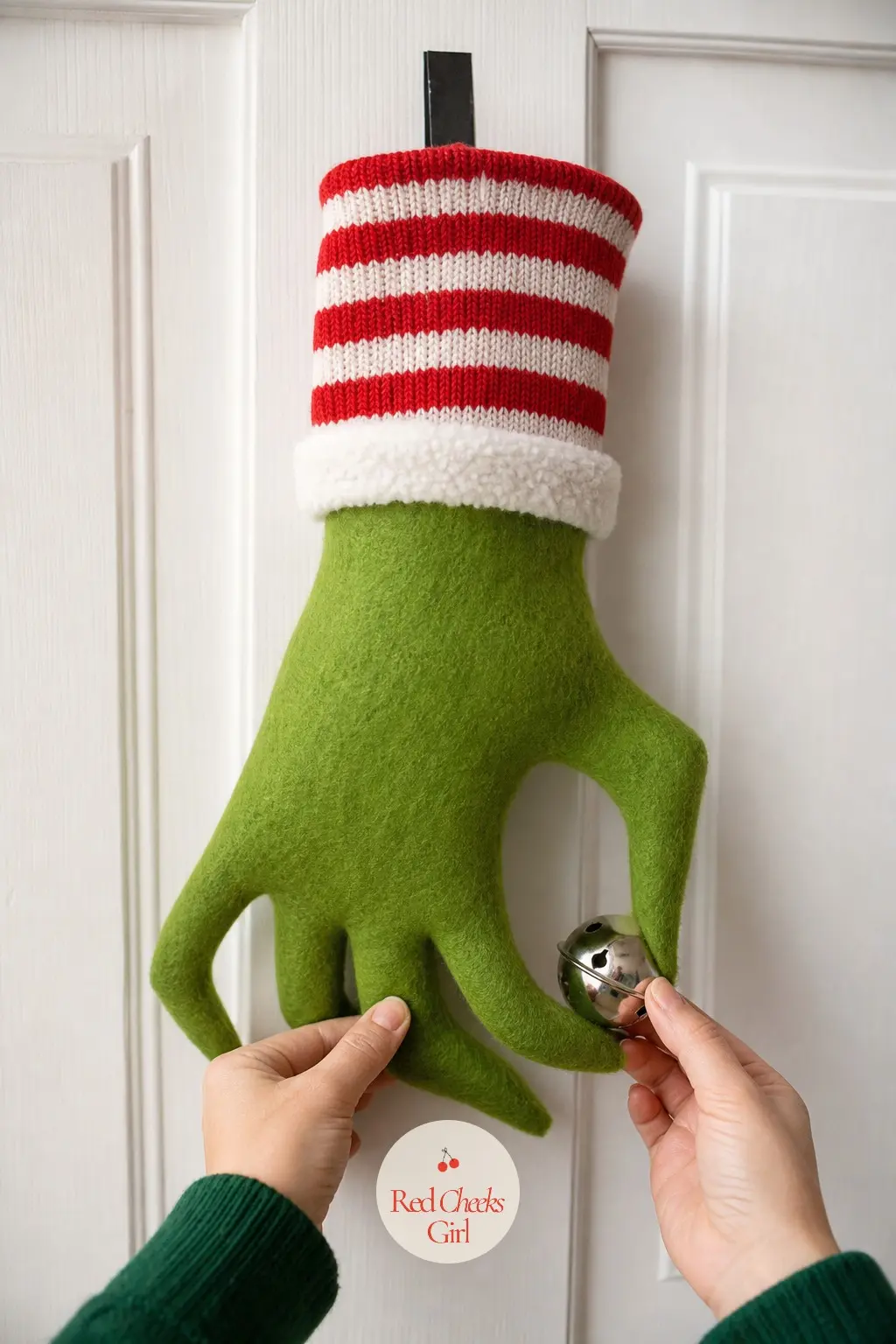 A Striped Sock Cuff Grinch Hand Wreath for the Kids Bedroom Door — A simplified, kid-friendly build: a green felt hand cut flat (no stuffing needed) gets a red