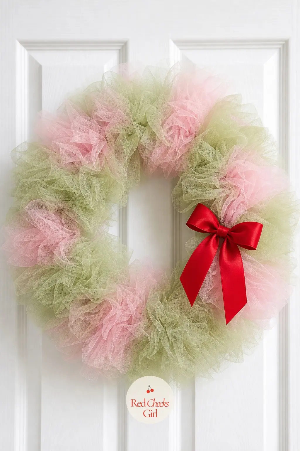 A Tulle Cloud Grinch Wreath in Sage and Whoville Pink for the Nursery Door — For a room where a snarling face is too much, this version pulls the palette from