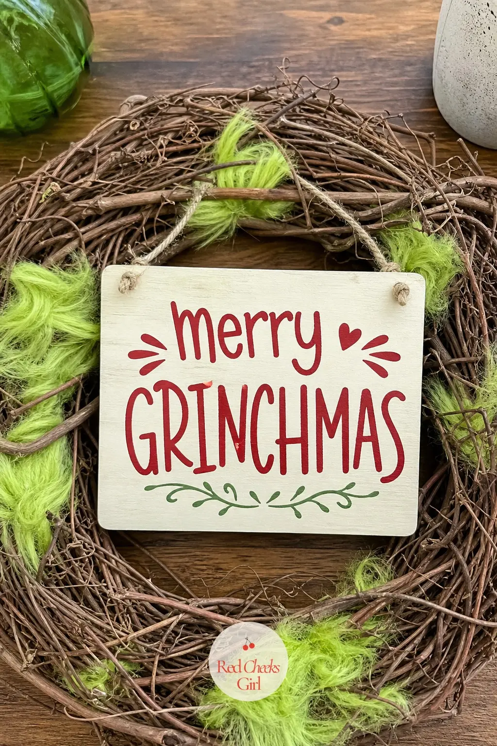 A Wooden Merry Grinchmas Sign Wreath on Bare Grapevine for the Entry Table — Laid flat on a table rather than hung, a bare grapevine wreath looks almost