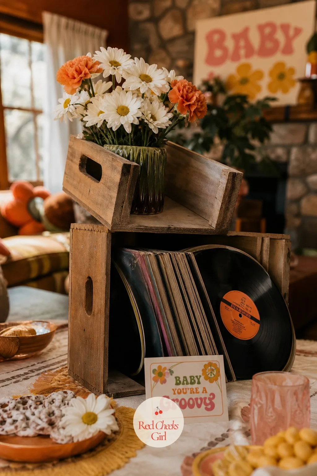 Stacked Vinyl Crate Centerpiece — A centerpiece needs height or it disappears under taller guests' sightlines across the table. Groovy baby shower ideas