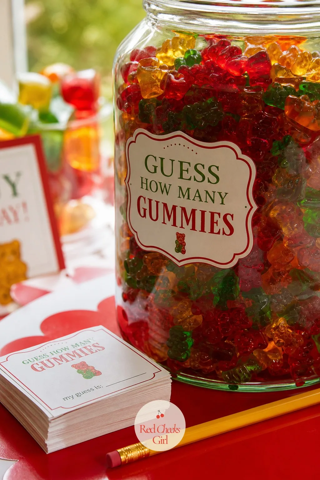 Guess How Many Gummies Game — Fill one large clear jar with a counted number of gummy bears and set it beside a stack of small paper slips and a pencil. Gummy