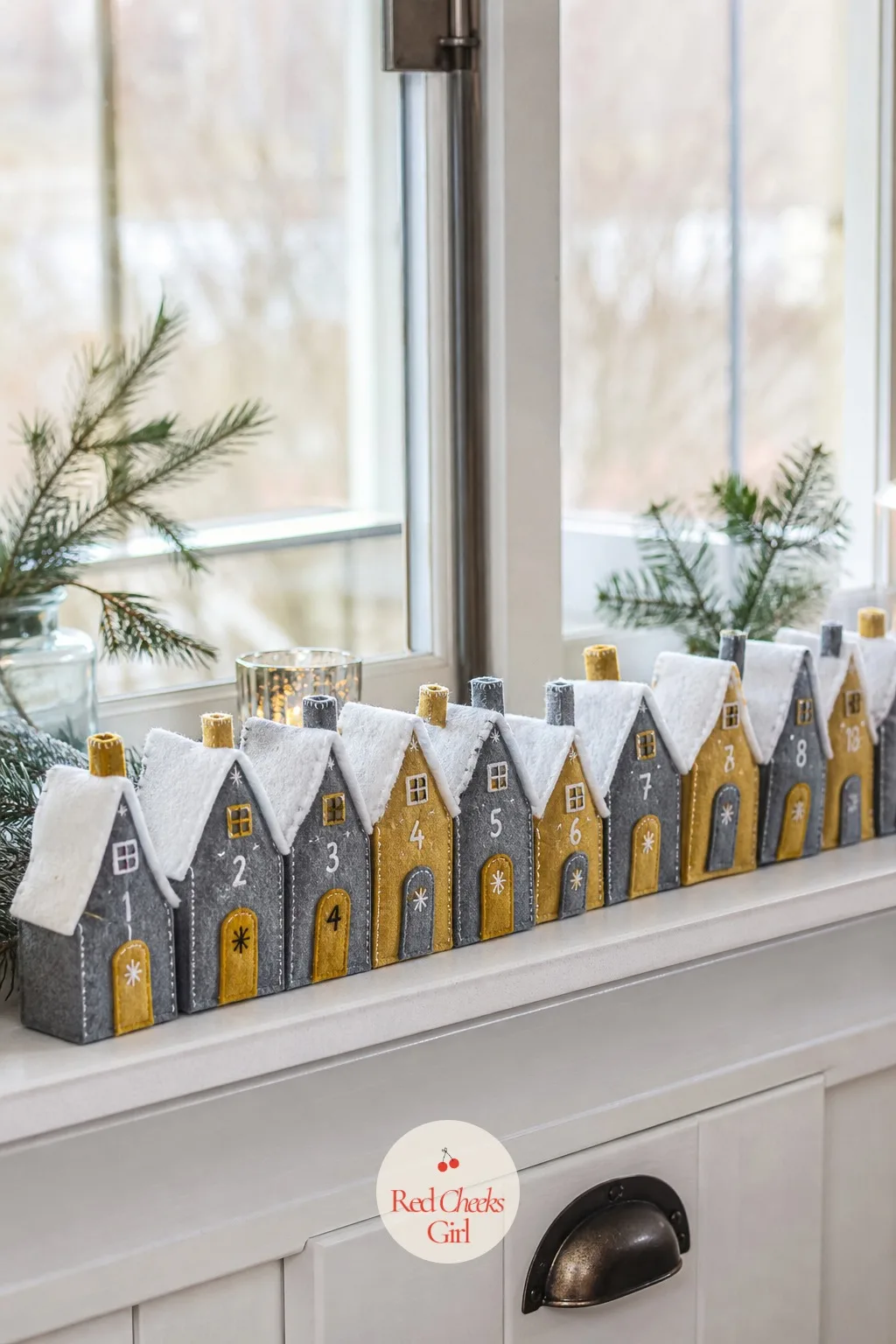 Felt Scandinavian House Village Advent Row — A straight line of houses reads as a street rather than a calendar, which is exactly the point. Handmade advent