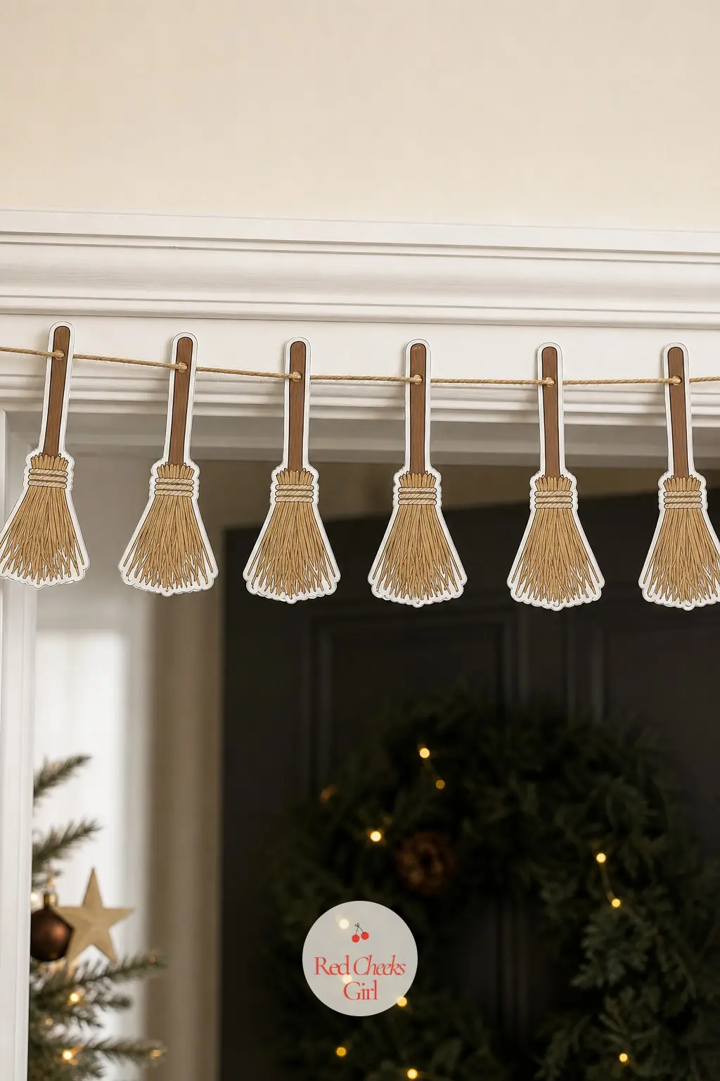 Broomstick Garland — A long handled broom with a fan of straw colored twigs at one end, bound with a few wraps of cord, lying on its side the full length of
