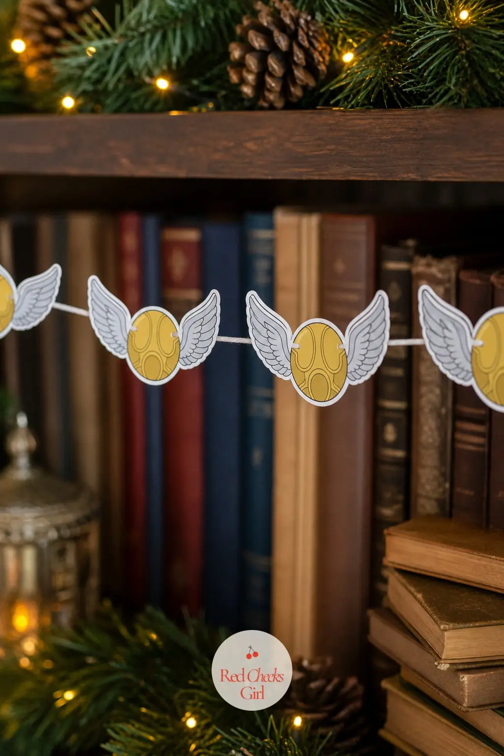 Small Golden Winged Balls — A small gold ball with a pair of narrow silvery wings either side, this garland is the lightest touch of magic in the whole set