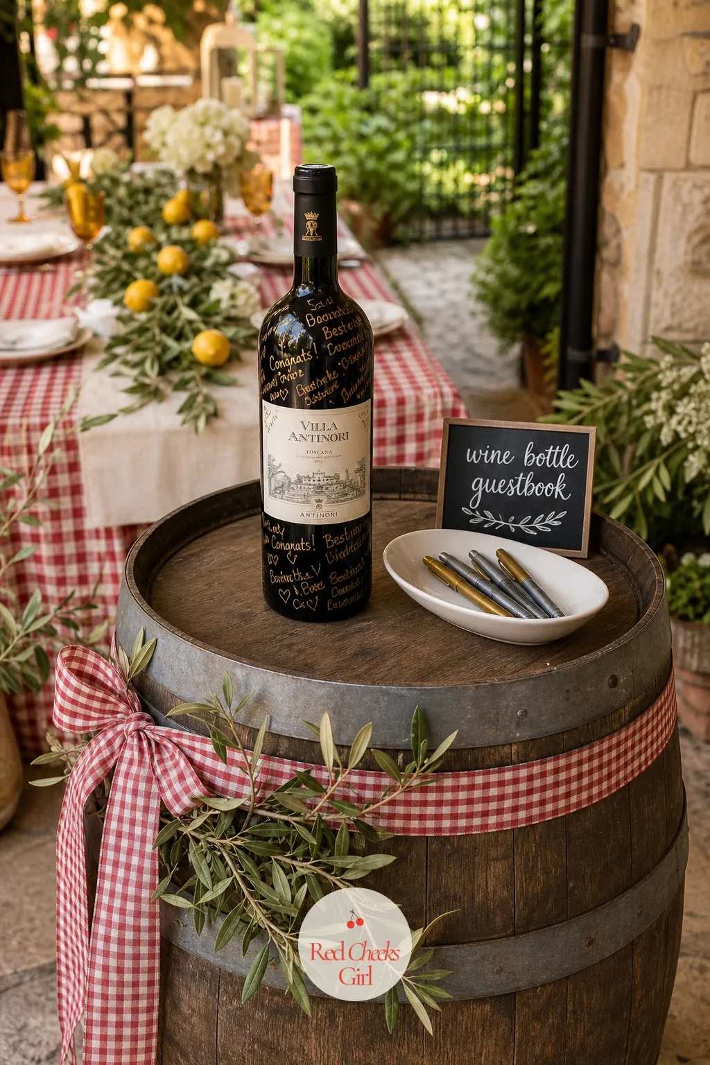 A Wine Bottle Guestbook — Instead of a book nobody reads twice, a bottle the couple actually opens: a wine barrel standing near the entry, a bottle of red