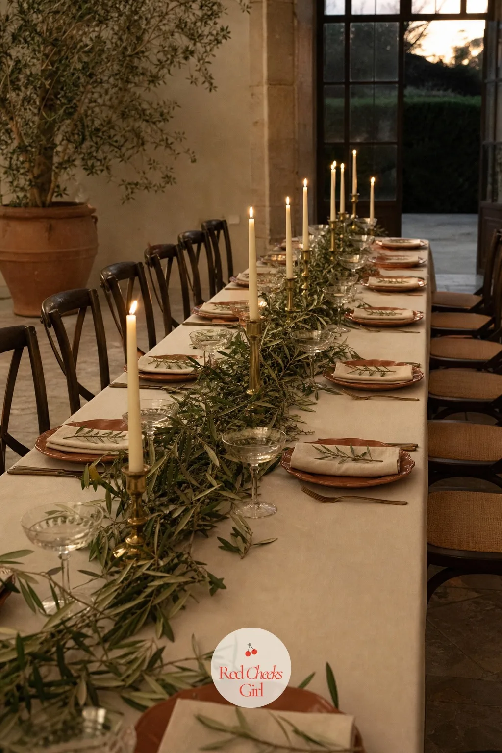 Long Reception Table with Olive Branches and Taper Candles — A round table with one centrepiece looks like a hotel conference dinner. Italian wedding aesthetic