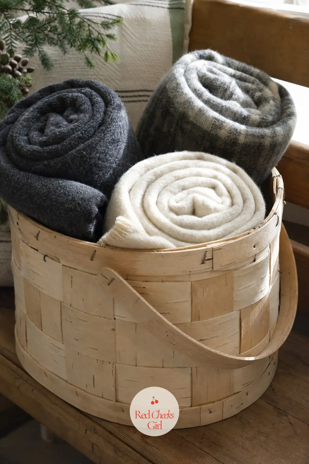 A Woven Birch Basket of Rolled Wool Blankets on the Bench — Once the stockings are folded away, the entry bench has nowhere to put its energy. January decor