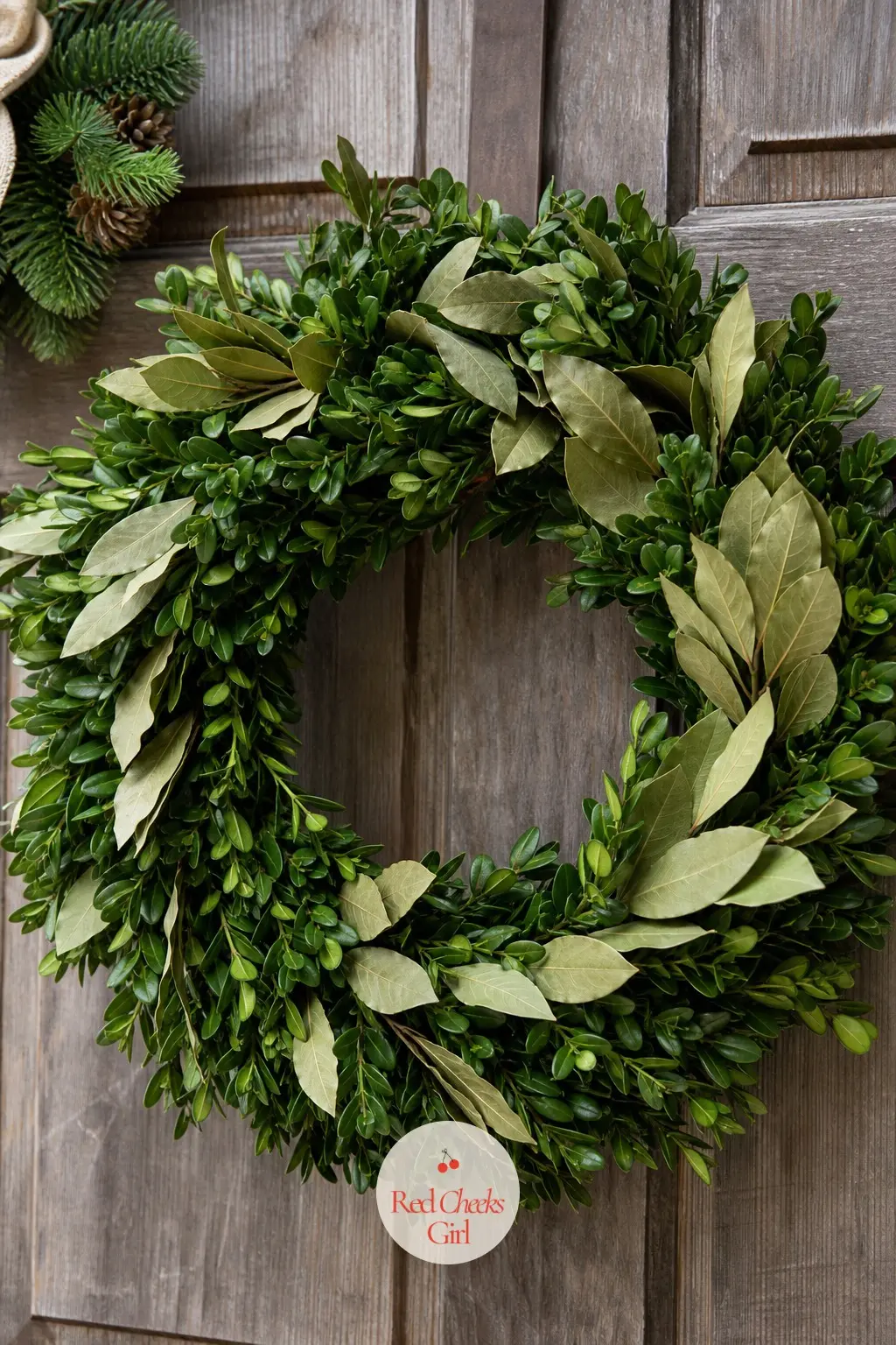 The Boxwood and Bay Leaf Wreath for the Front Door — A dense faux boxwood base tucked with dried bay leaves keeps the formal, tailored look a front door wants