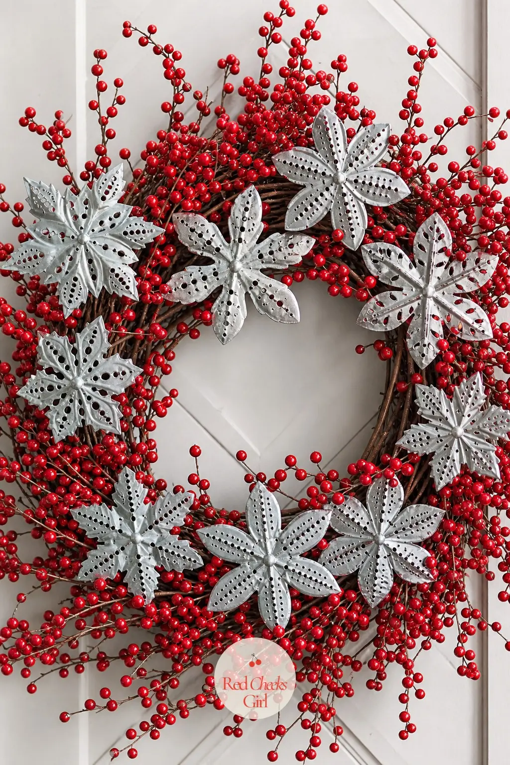 The Punched Tin Snowflake and Winterberry Wreath for the Carriage Door — Small punched tin snowflake ornaments catch porch light next to stems of bright red