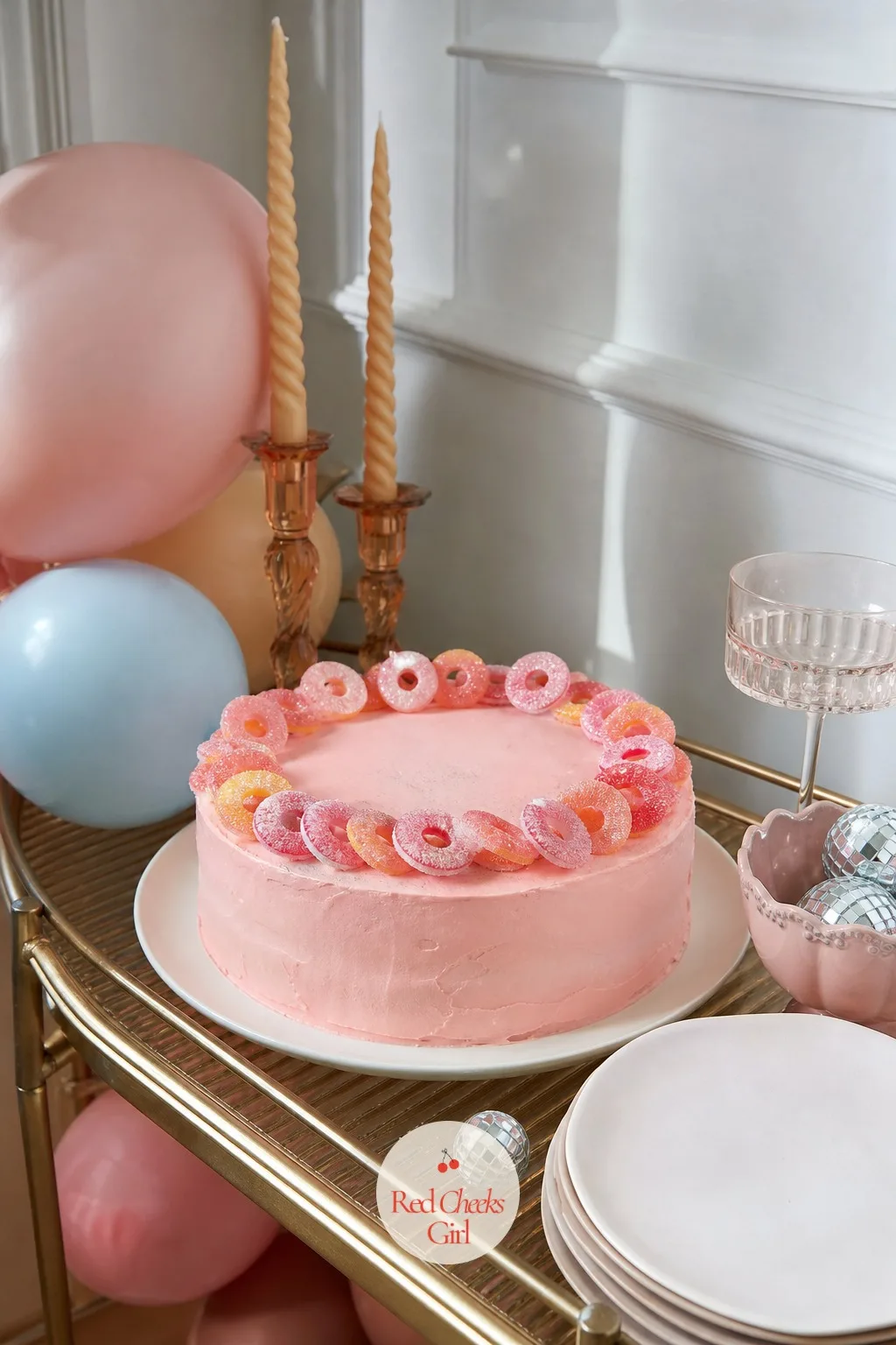 Cake Crowned With Candy Rings And Glitter — A ring of plastic candy rings sitting on top of a cake looks like a dare, the kind of thing nobody expects a grown