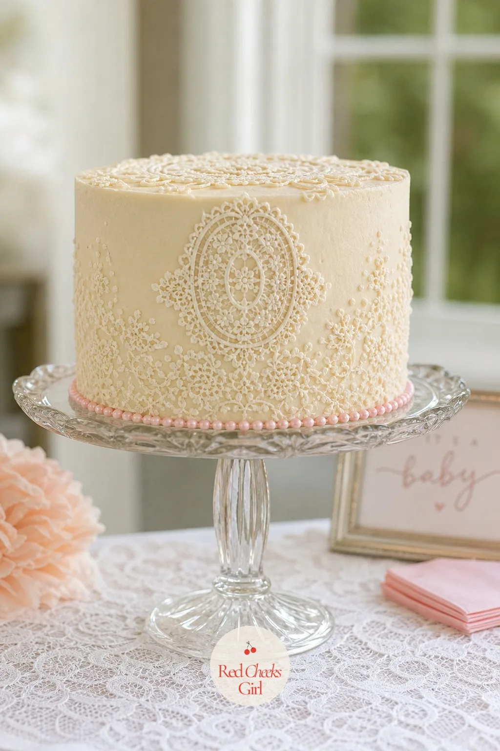 Lace-Piped Buttercream Cake on a Pedestal Stand — A plain round cake can feel like it is missing something next to all that fabric behind it. Lace baby shower