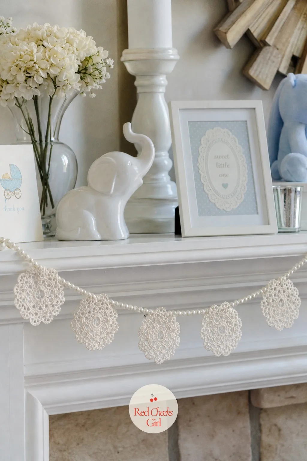 Tatted Lace Doily Garland on the Mantel — Paper doilies look lovely but read a little disposable next to a shower built around heirloom texture. Lace baby