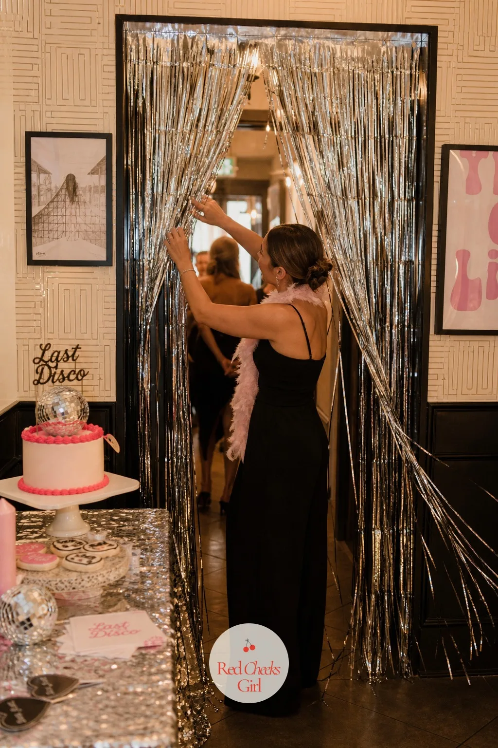 Silver Fringe Curtain — Right at the threshold into the party room, a wall of silver fringe catches every bit of light before anyone even reaches the dance