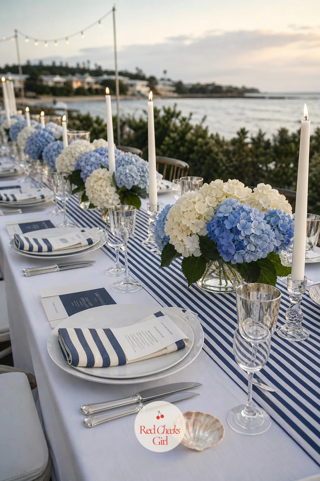 The Striped Tablescape with Hydrangeas — This is the table everyone actually sits at, so the stripe here runs finer than the bold cabana weave up front, and