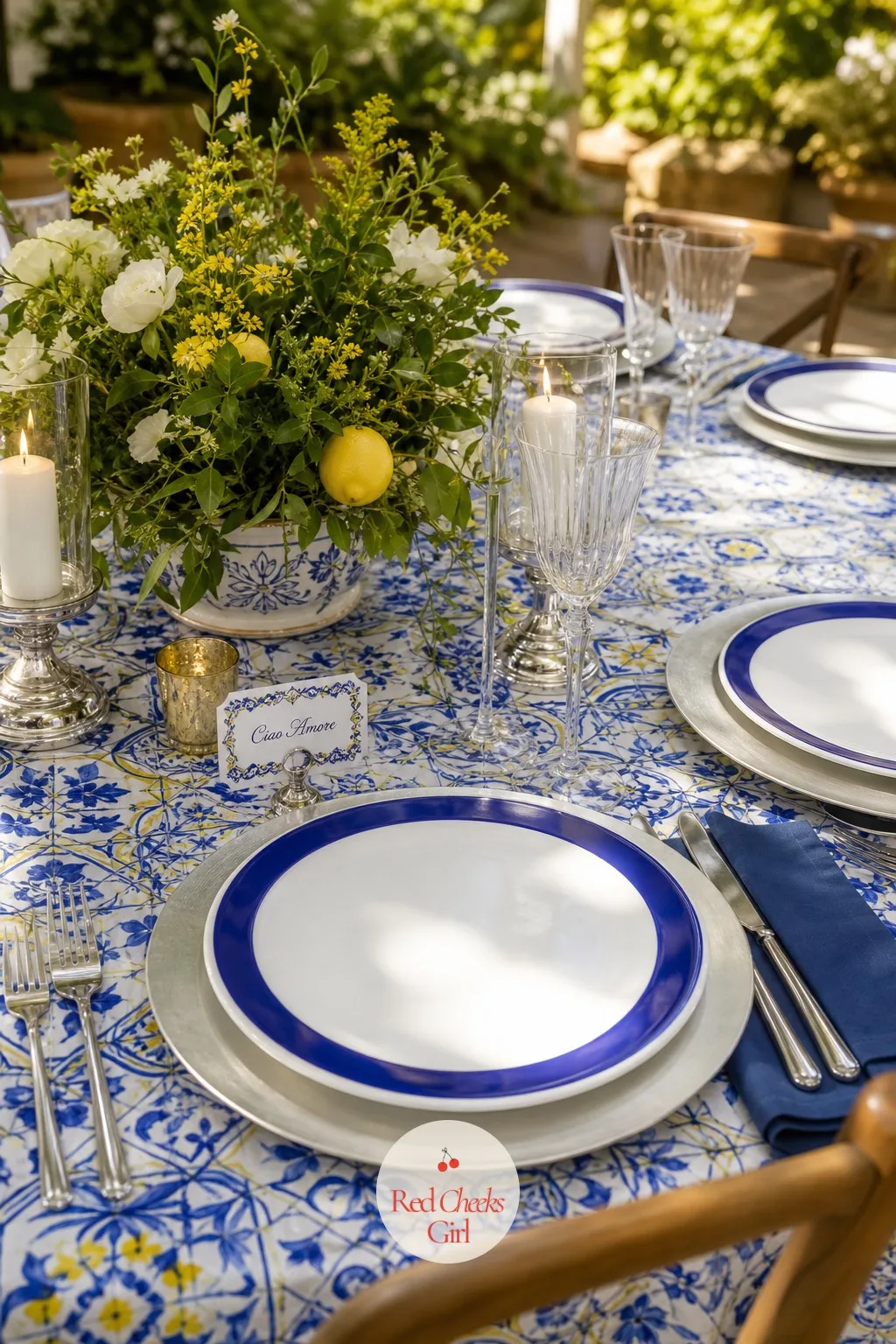 Cobalt and White Dinner Plates at Each Place — Paper plates would undercut everything the tablecloth just built, so each place setting carries real weight