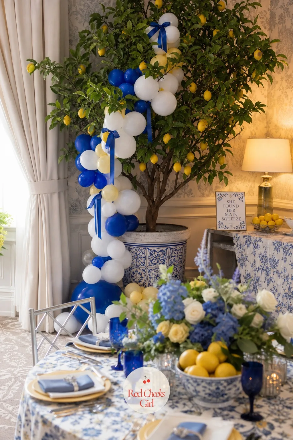 Lemon Tree Backdrop with Cobalt and White Balloon Garland — A bare corner behind the gift table says nothing about the day ahead. Lemon and blue bridal shower