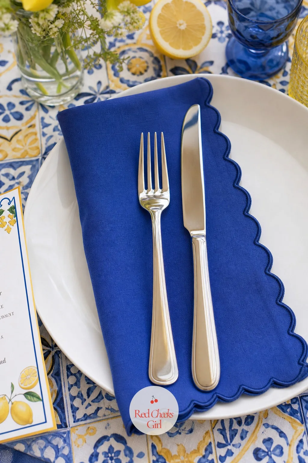 Scalloped Blue Napkins Under the Cutlery — A stiff folded paper napkin looks like an afterthought next to everything else on this table. Lemon and blue bridal