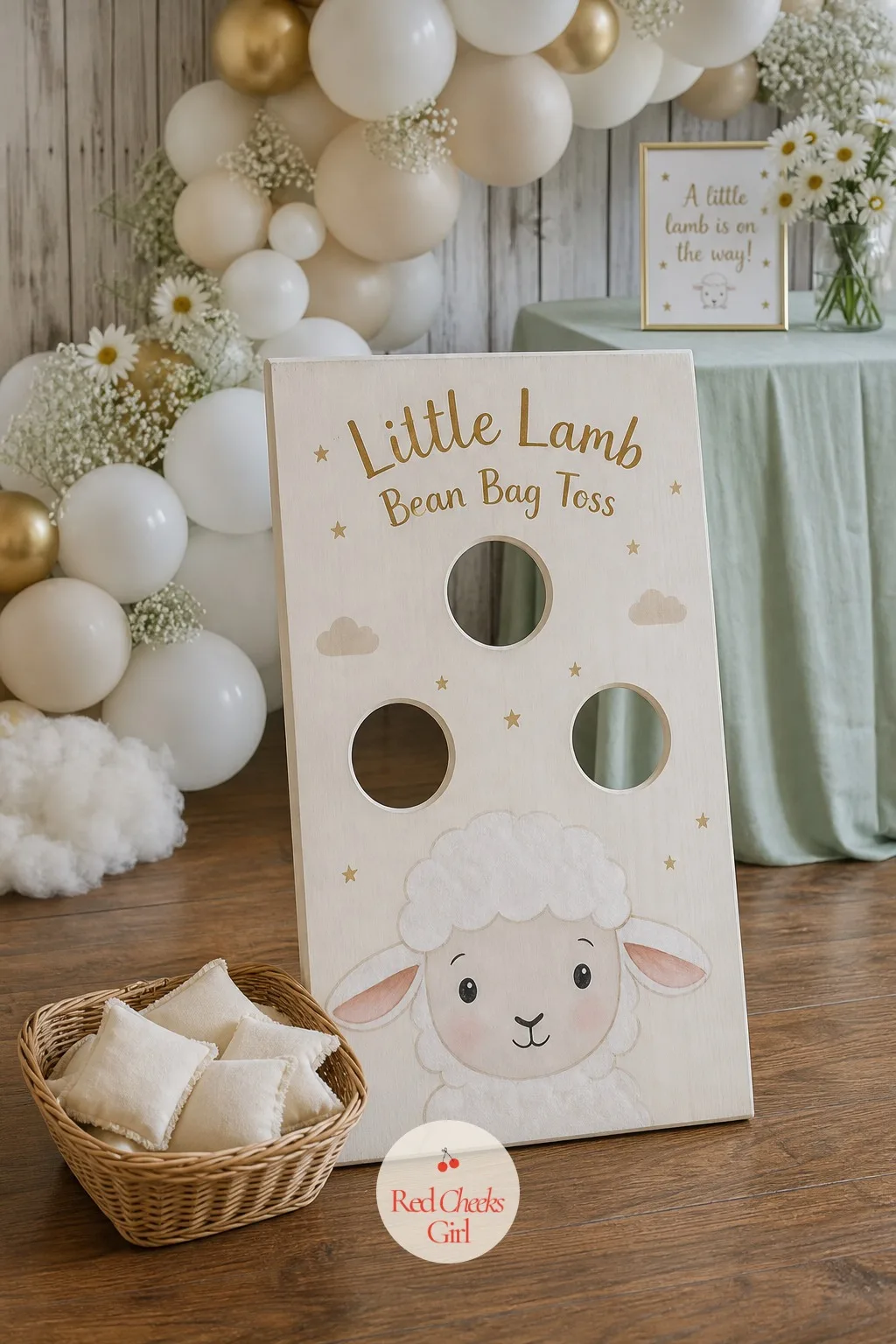 Little Lamb Bean Bag Toss — A wooden board painted with a lamb's face, three or four round holes cut where the cheeks and chin would sit, leans against a wall
