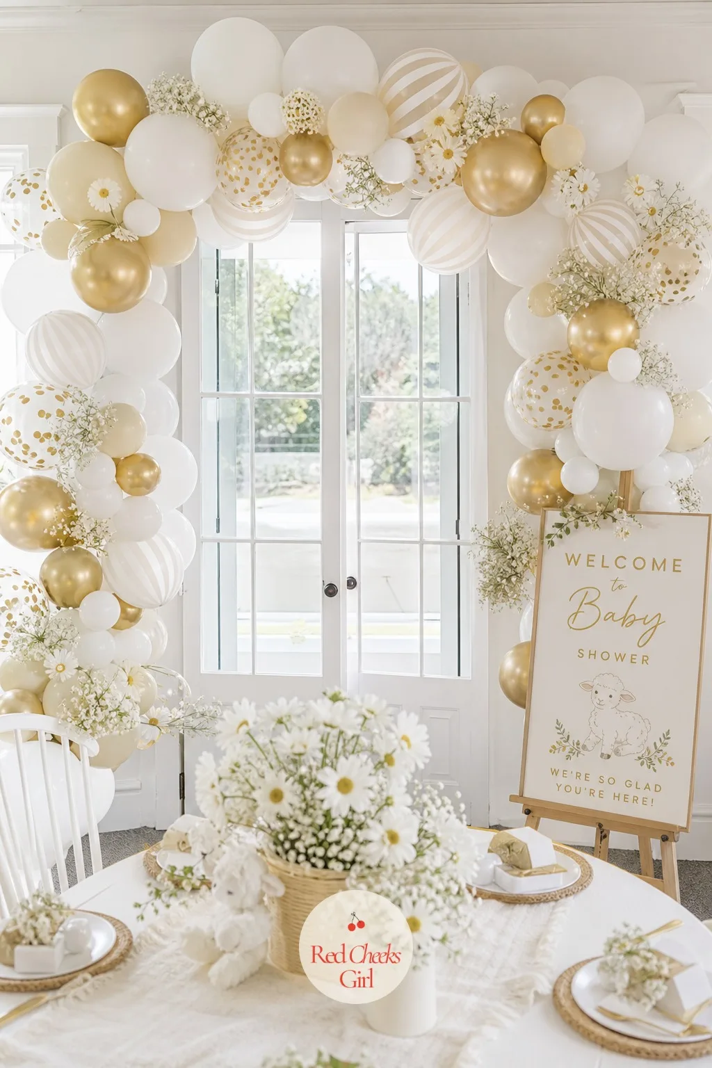 White Stripe and Gold Balloon Arch — An arch built from white, cream and metallic gold balloons in three sizes, taped into a balloon strip and curved over the