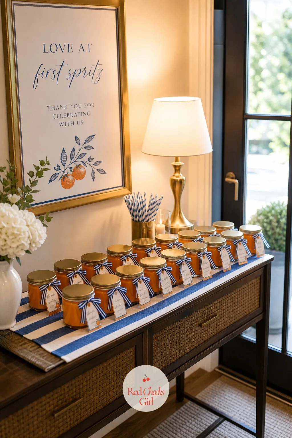 The Orange Candle Favors — Lined up on a small table by the door, these are the favour every guest actually lights later instead of leaving in a drawer: a