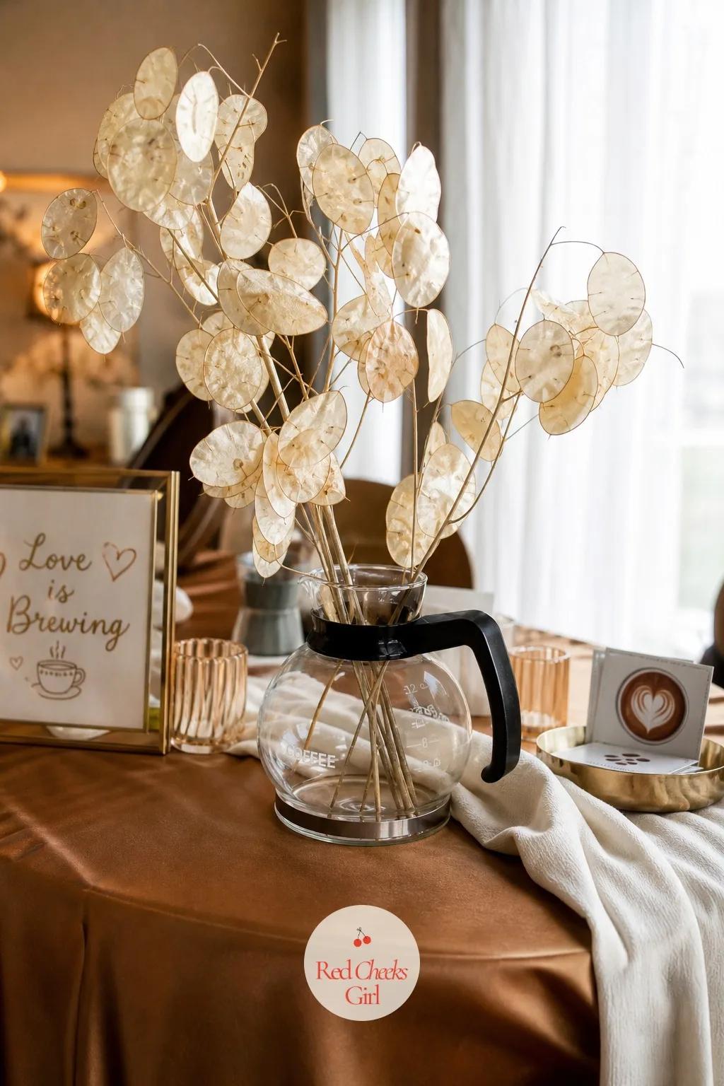 Coffee Carafes as Vases — A plain bud vase would do, but a glass coffee carafe standing in for one makes every table say the theme without a single extra word
