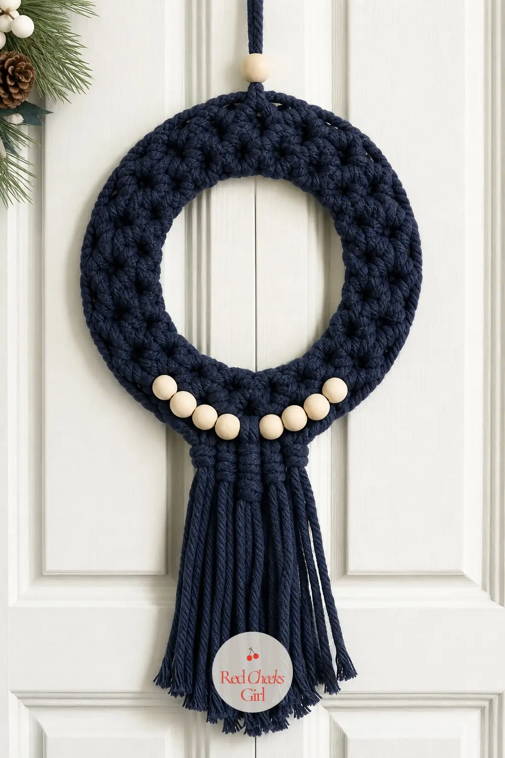 The Navy and Cream Macrame Wreath for the Pantry Door — Navy cord with cream wood beads and a loose knotted fringe, built for a door that gets opened